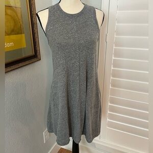Sleeveless, gray swing style dress with pockets.